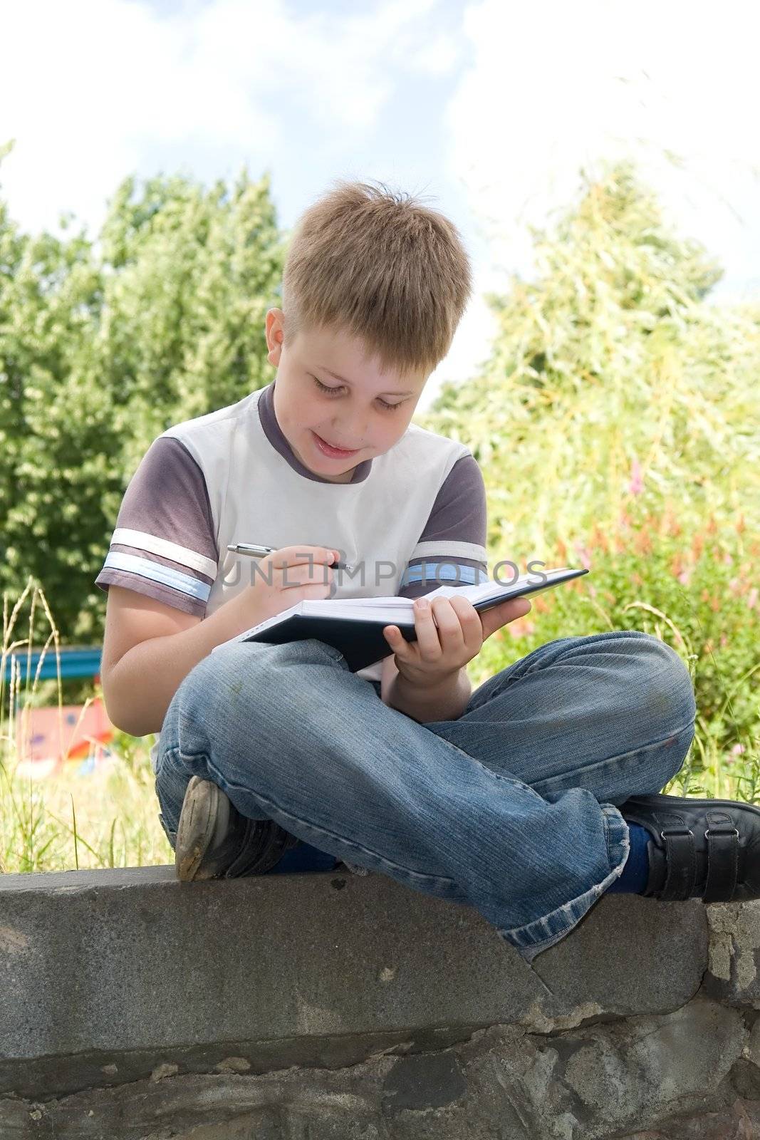 The little boy writes to writing-books
