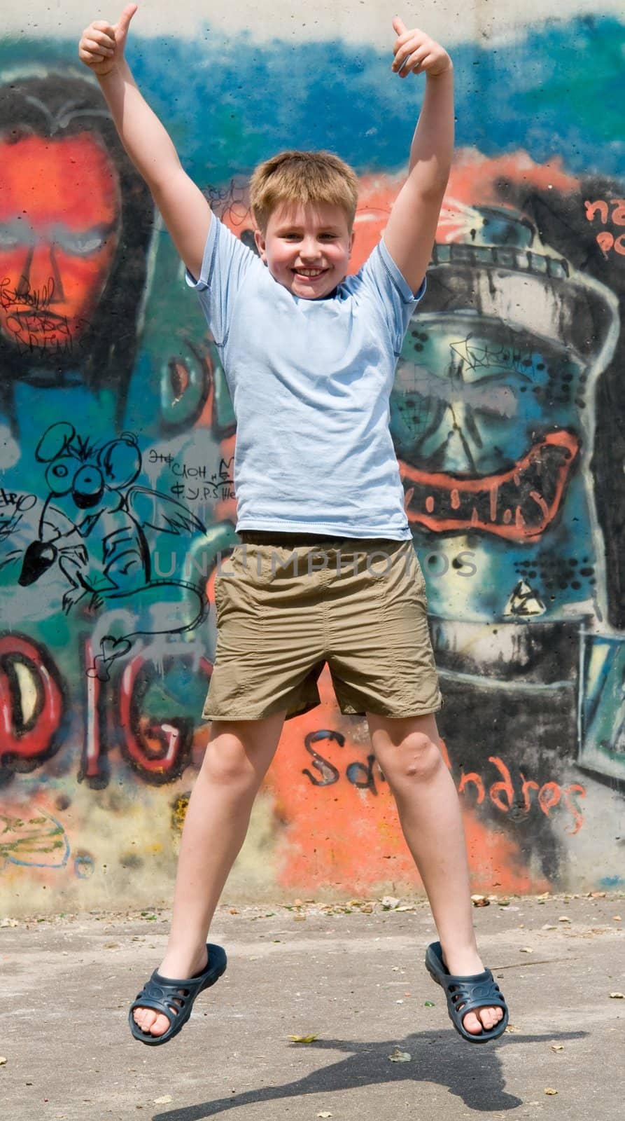 The jumping child with graffiti at background