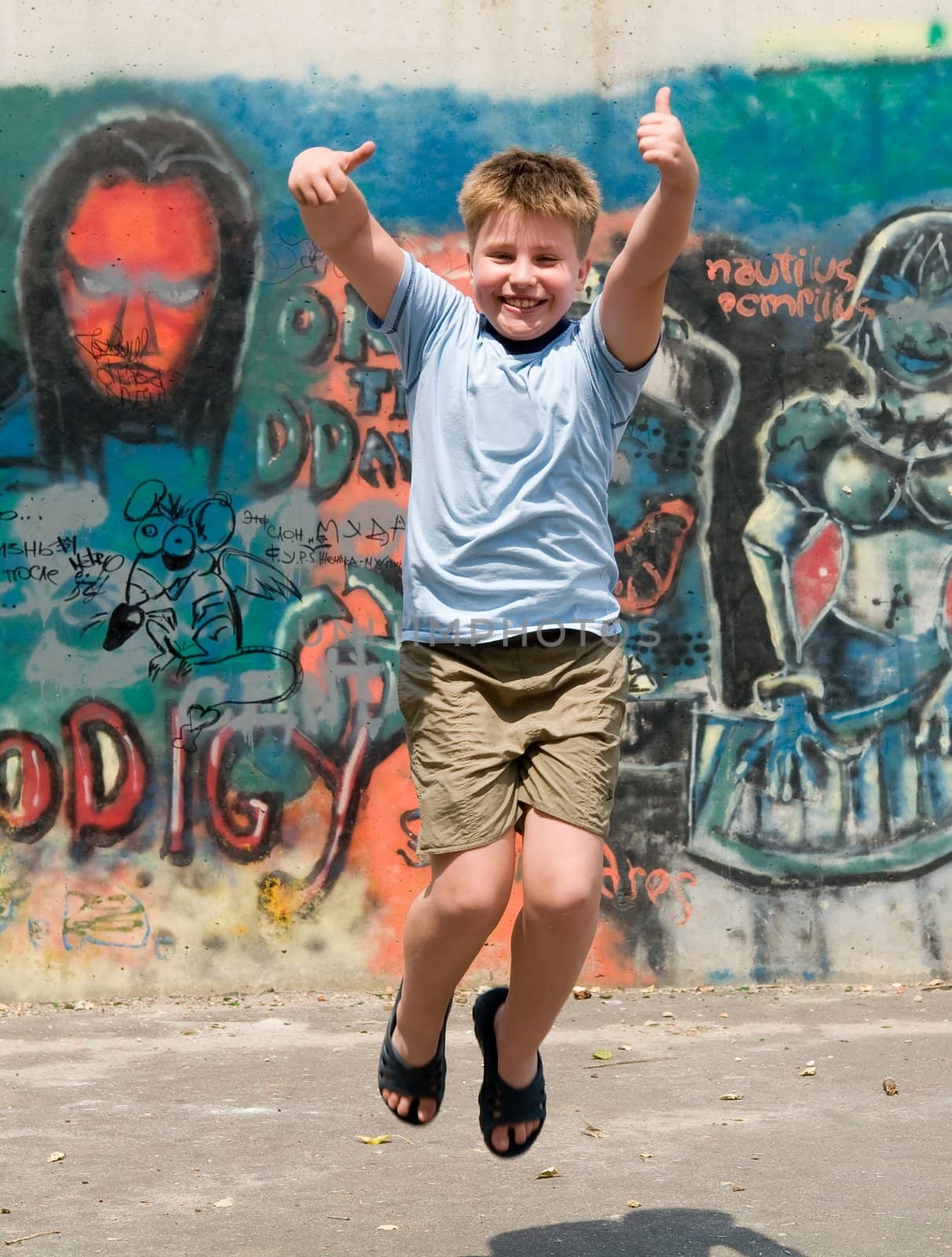 The jumping child with graffiti at background