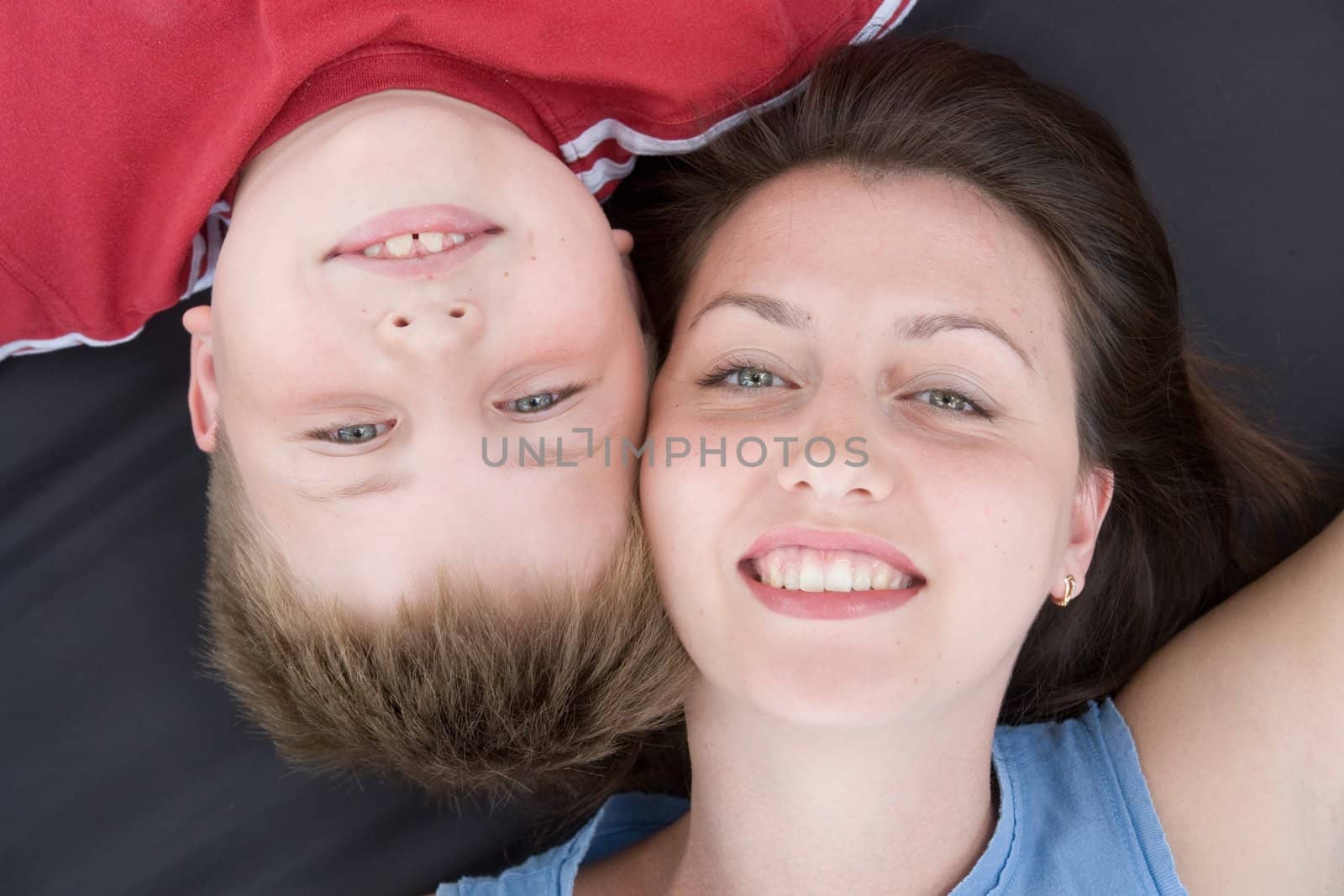 Mum and the son smile. A close up. The top view.