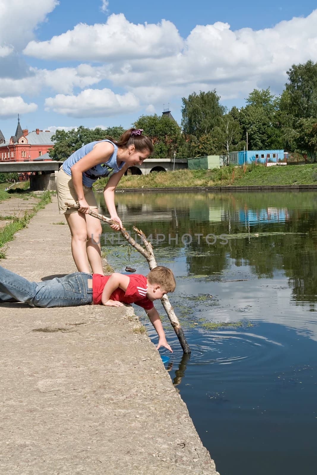 Mum and the son get a toy from the river