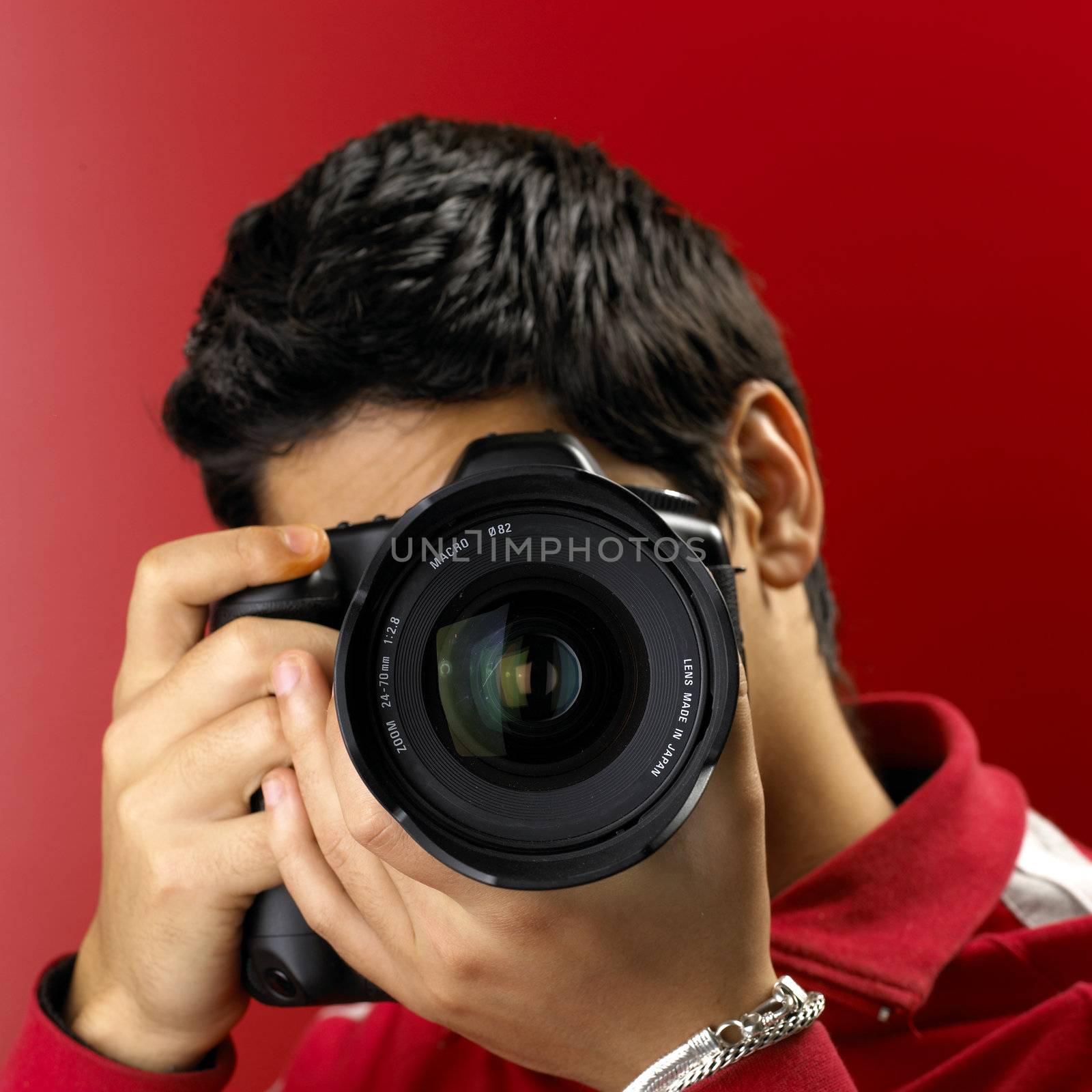 
Photographer on red. Shallow DOF. Focus on Lens.