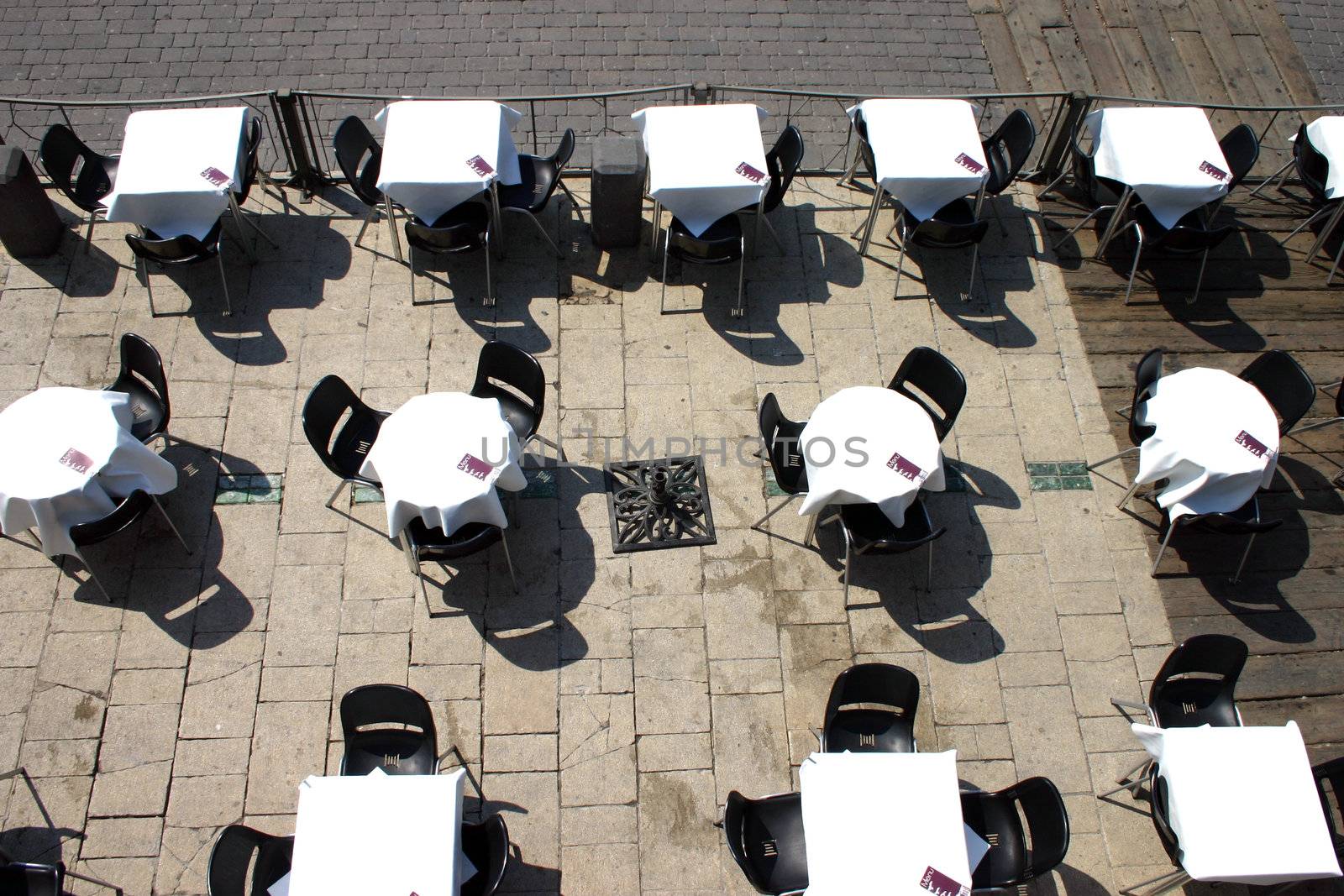 Several round tables in the typical cafe in Brighton on the pier
