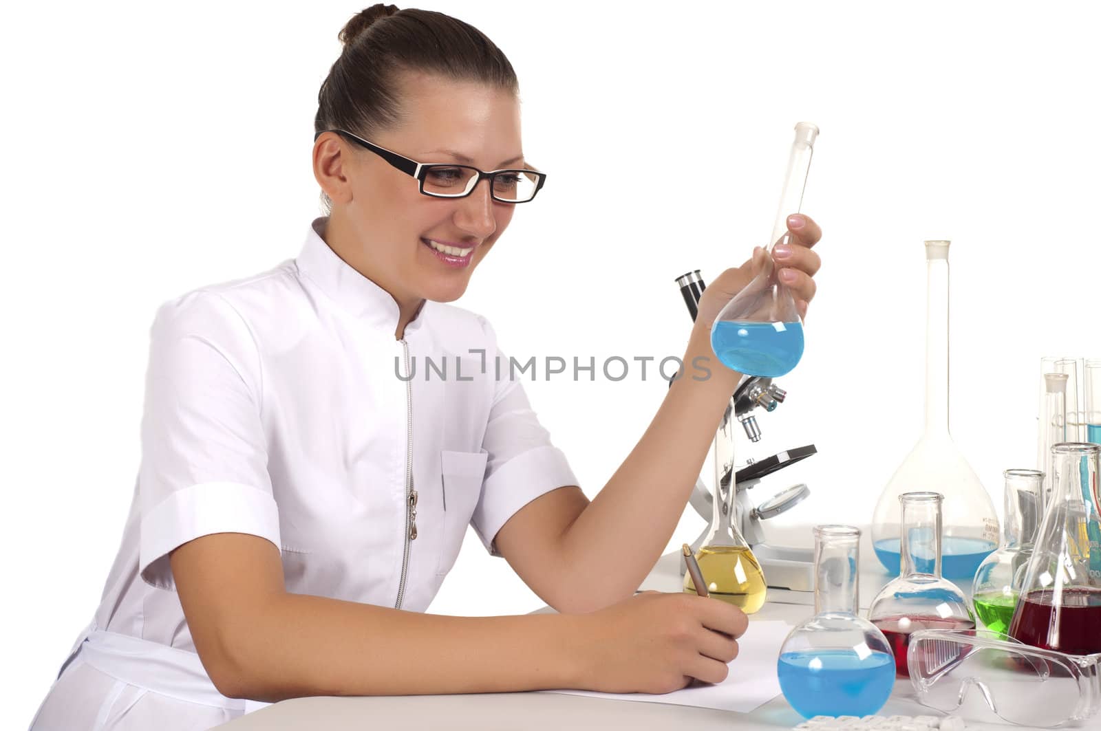 young woman scientist  chemist mixes the liquid in the tubes