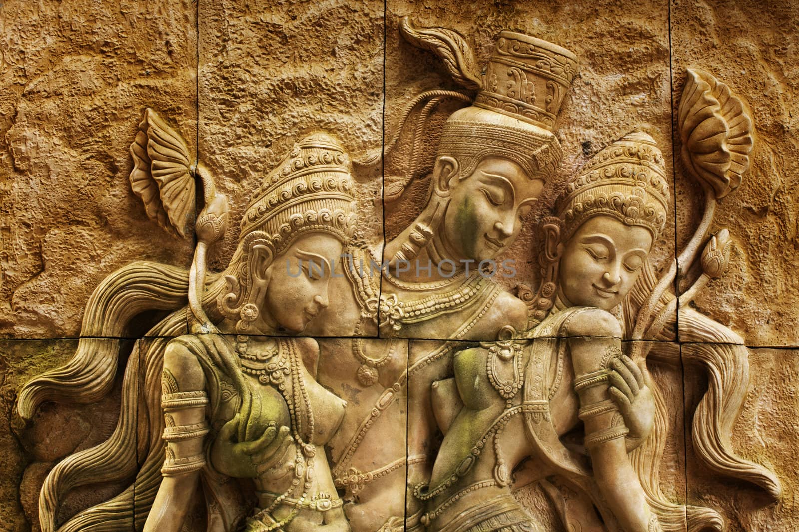 Traditional Thai stone carving on a wall - travel and tourism.