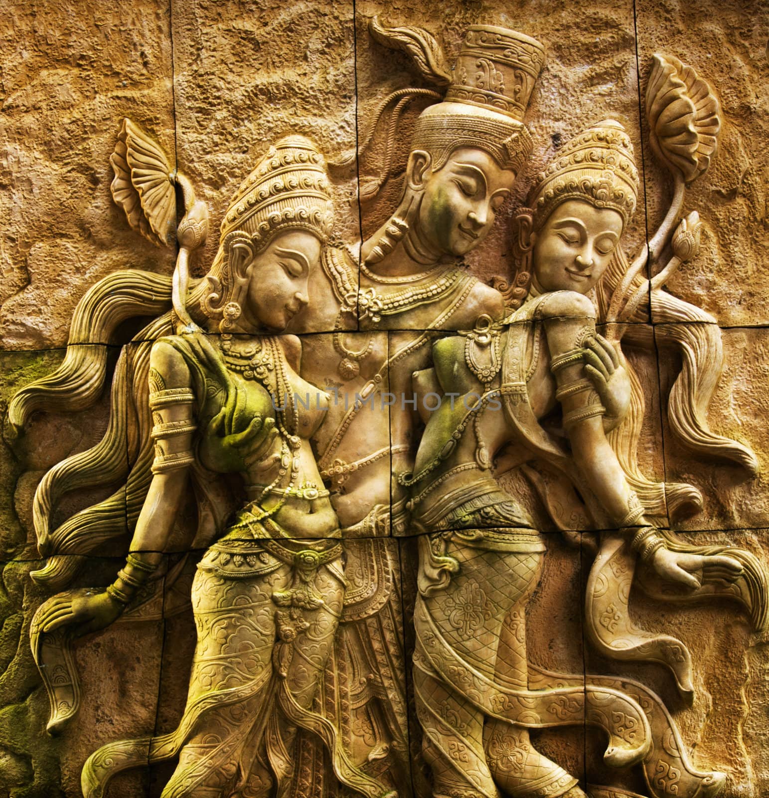 Traditional Thai stone carving on a wall - travel and tourism.