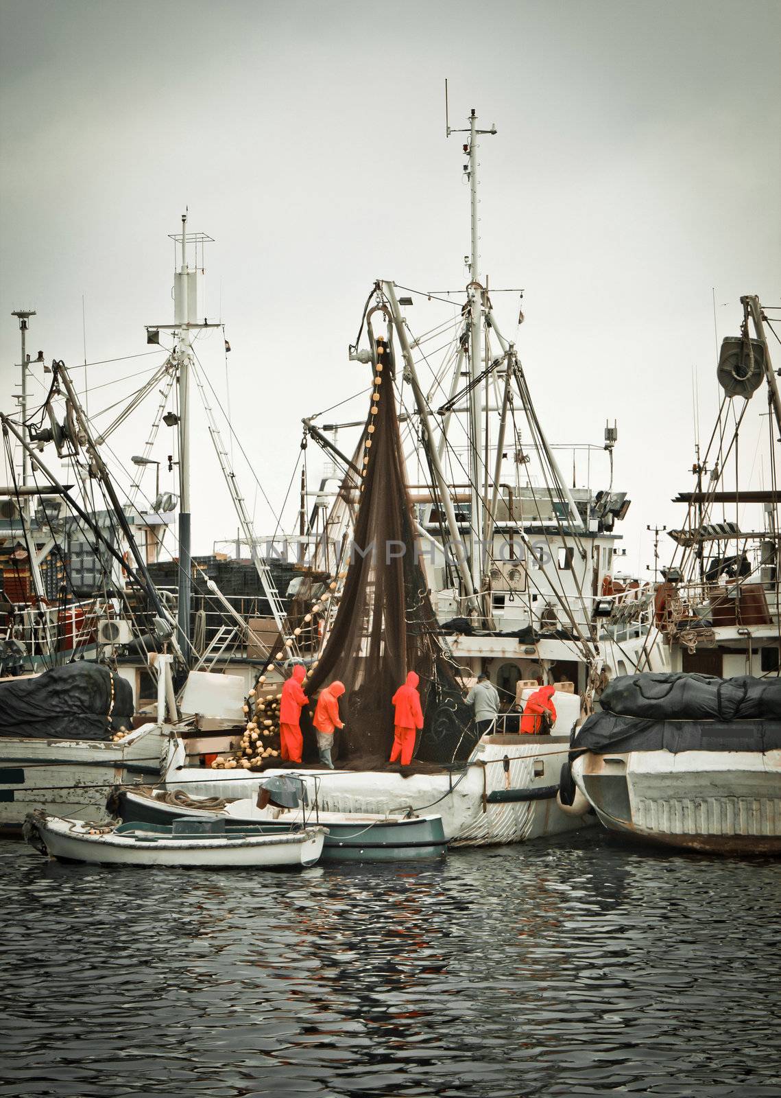 Fisherman crew fixing nets on fishing boat, Zadar, Croatia