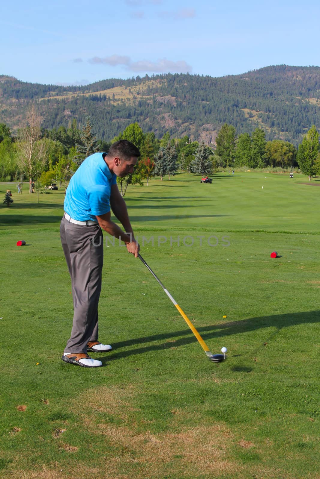 Young male golfer hitting his tee-shot with driver