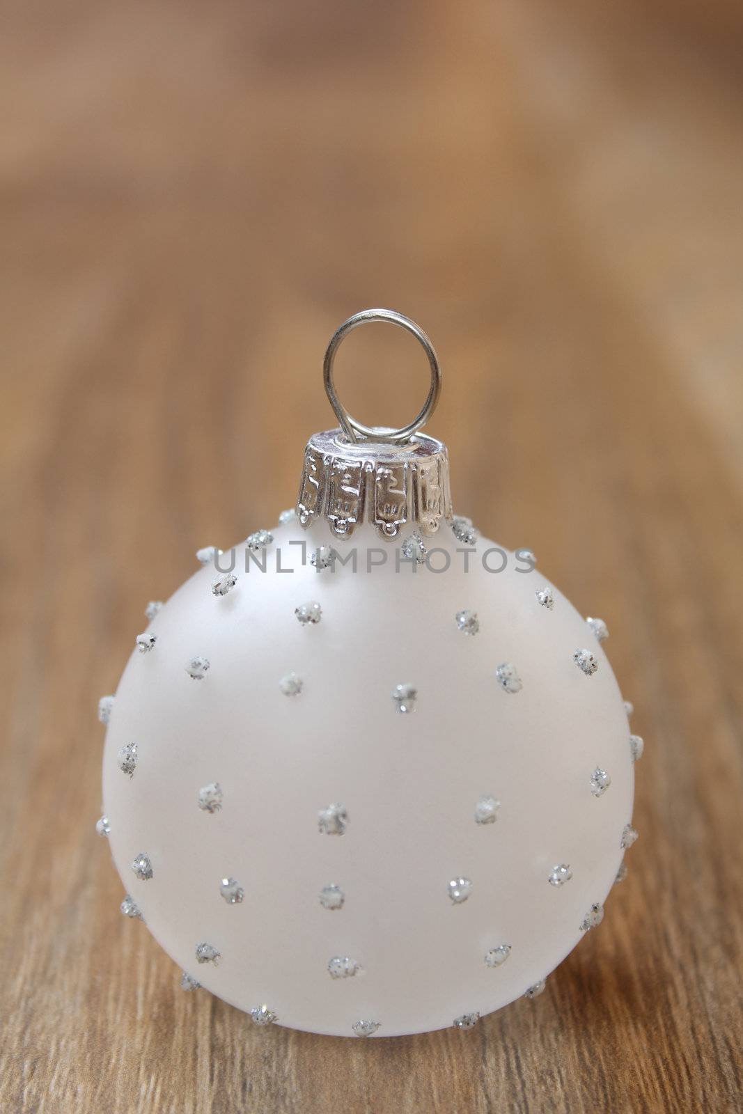 Glass christmas ball decoration on a wooden floor