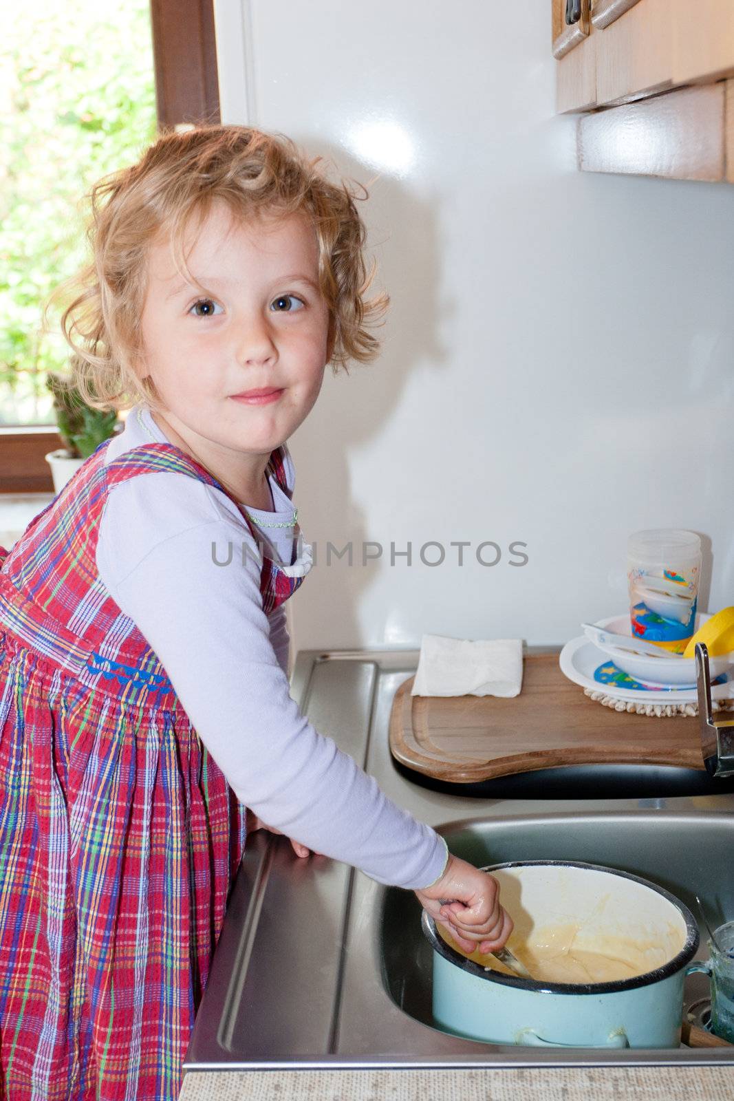 Little granddaughter helping grandma in a kitchen