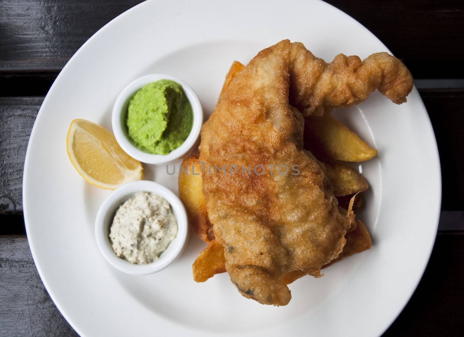 British pub food: fish and chips served with mushy peas and tartare sauce