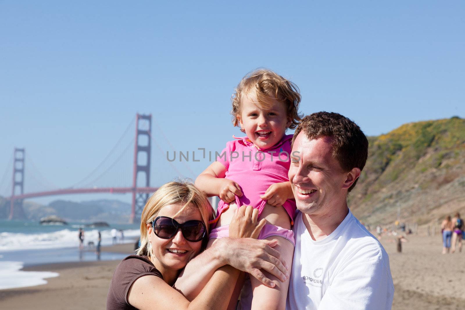 European family playing on Baker Beach in San Franciso, California.