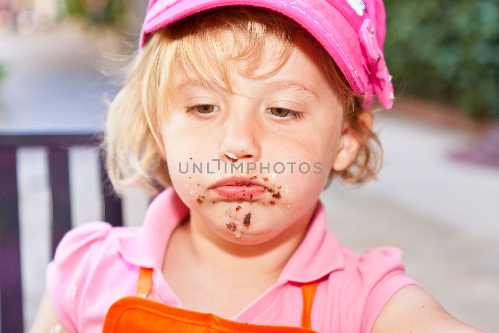 Eating a delicious chocolate cupcake with chocolate frosting.