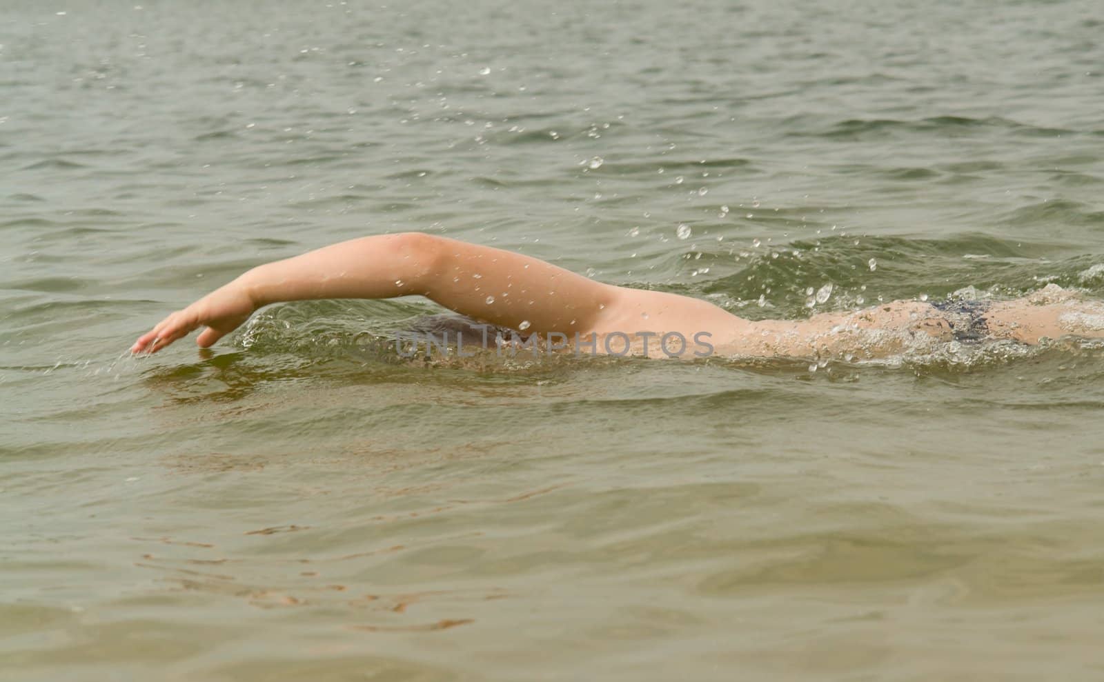 the little boy quickly swims the crawl