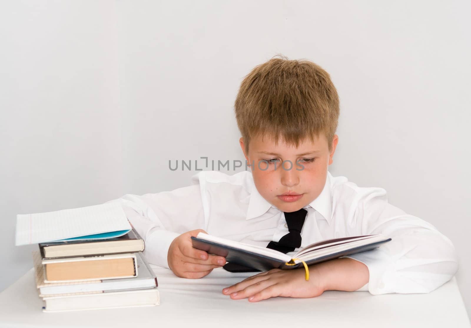 a young boy studying his homework