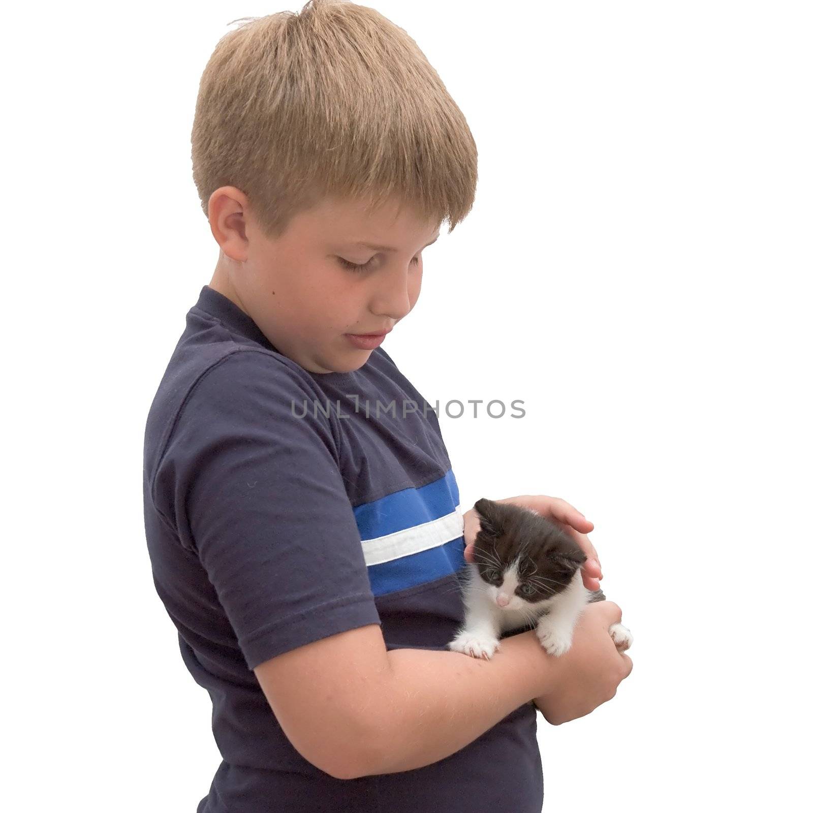 A young boy cuddling his pet kitten