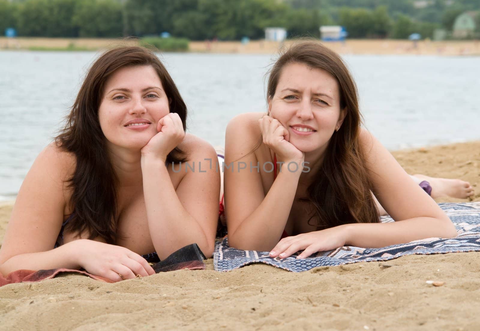 Two young pretty women on a beach