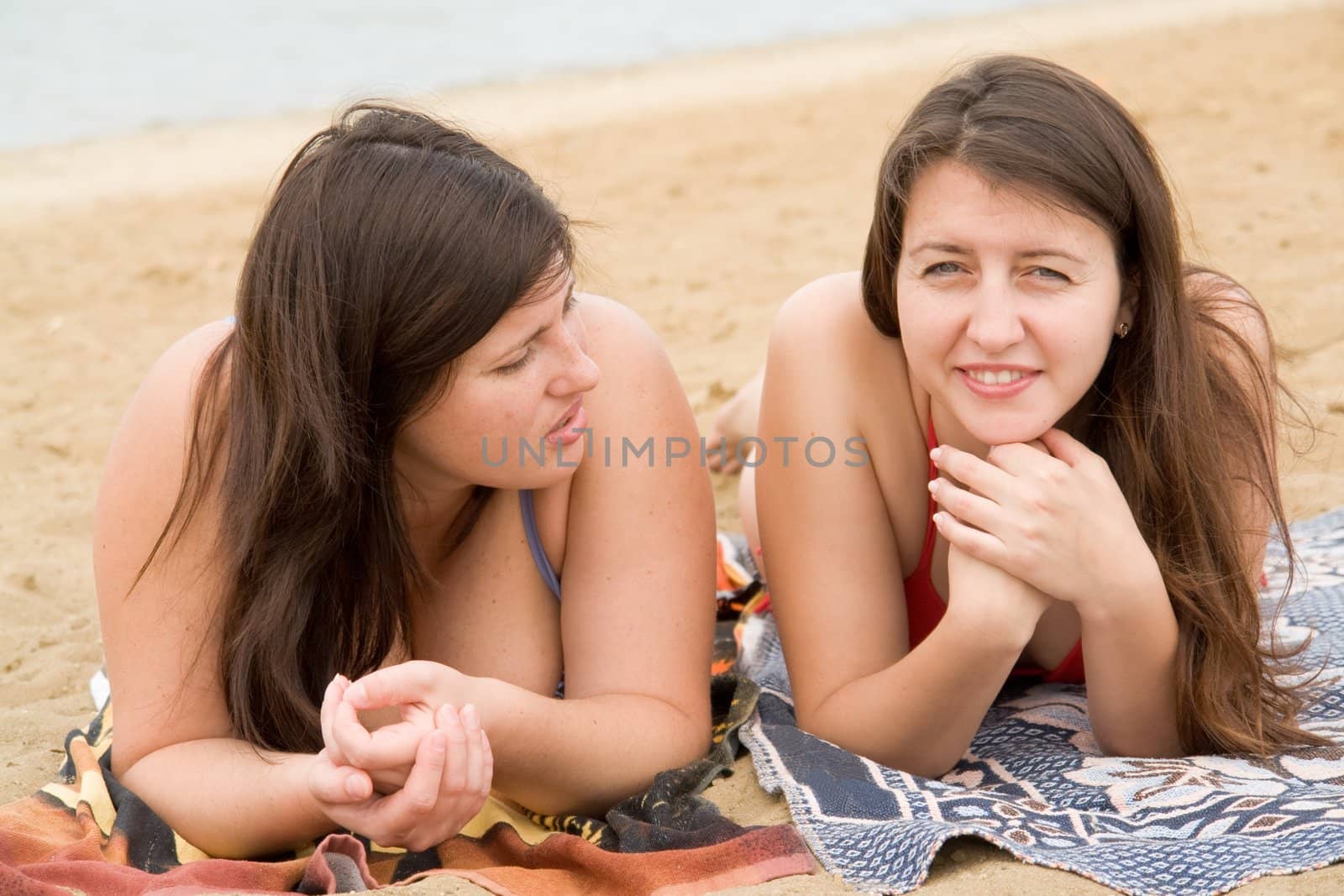 Two young pretty women on a beach