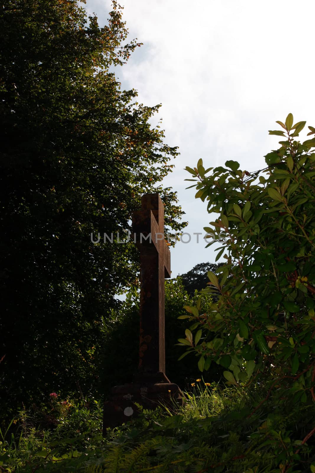 an old celtic cross in a church graveyard in cork ireland