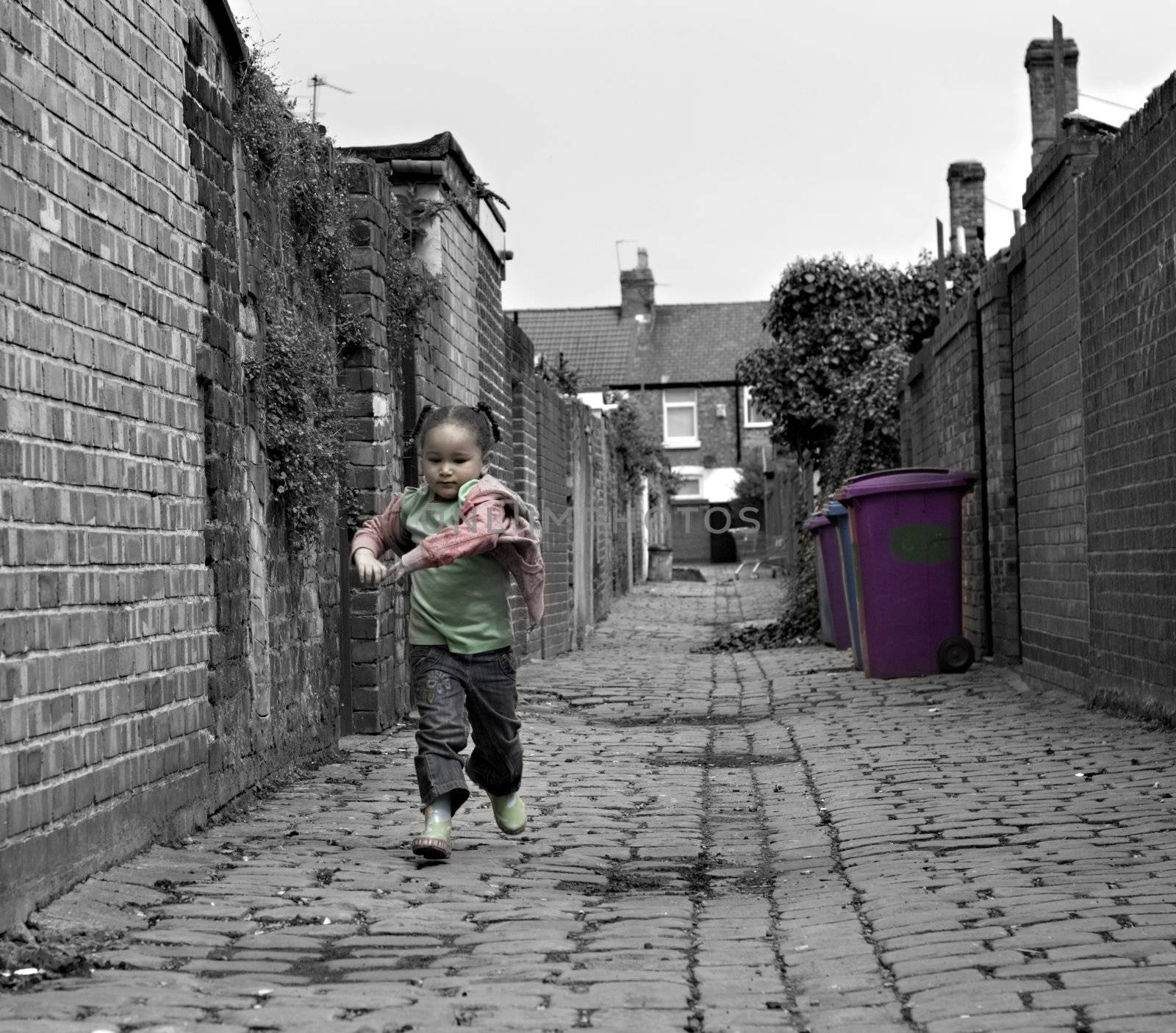 Young black baby girl playing on cobble stoned alley by illu