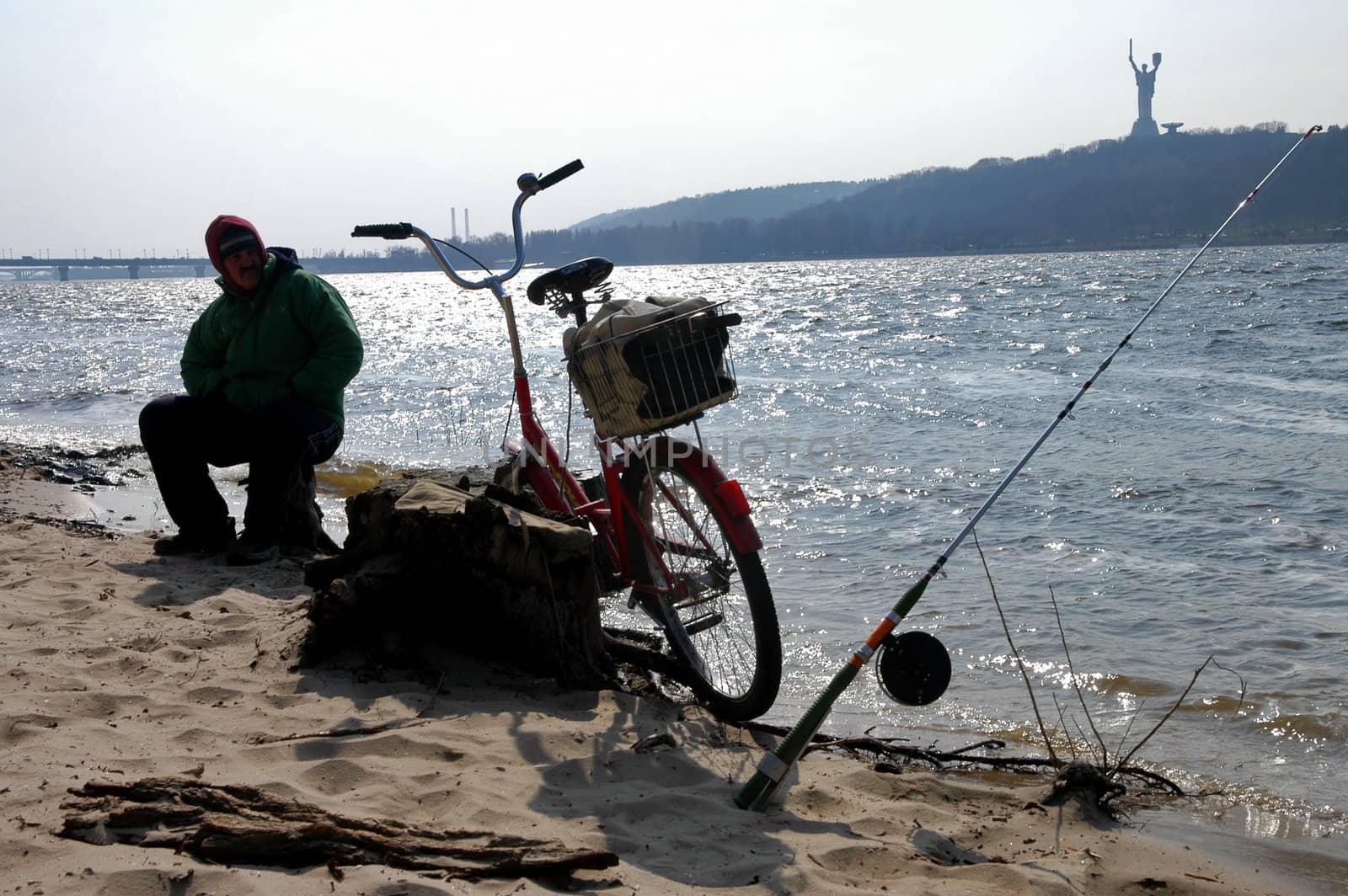 Sillhouette of a man fishing                                