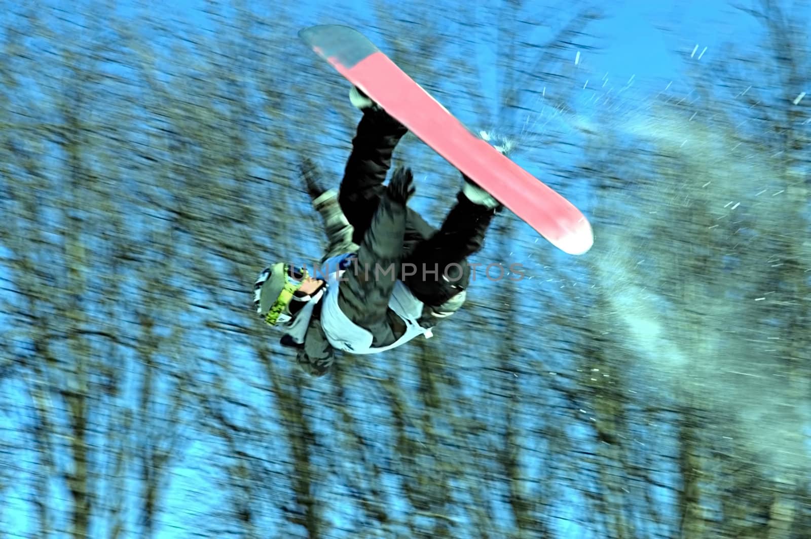 A snowboarder going big high above the half pipe                                      