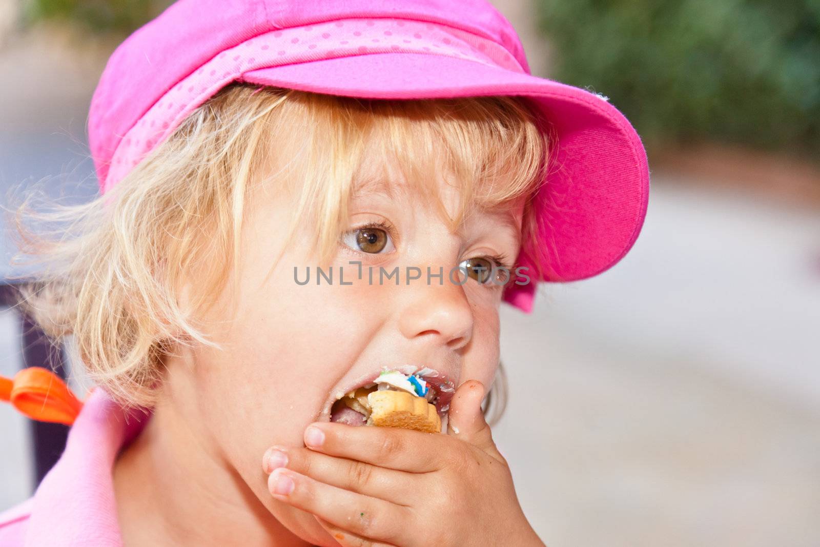 Eating a delicious cookie with cream frosting.