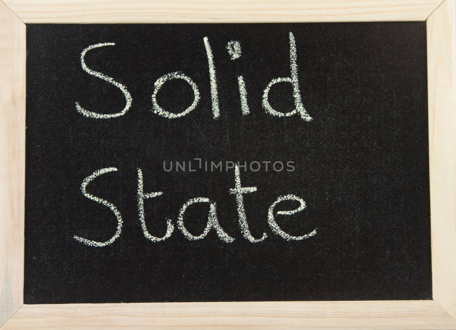 A black board with a wooden frame and the words 'SOLID STATE' written in chalk.