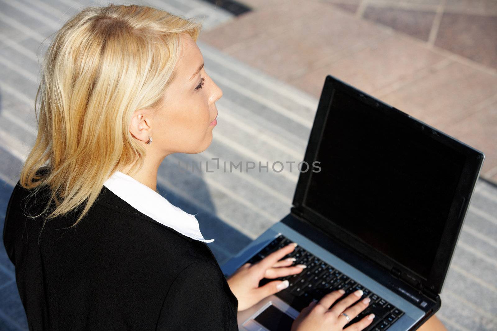 Businesswoman using laptop computer by Luminis