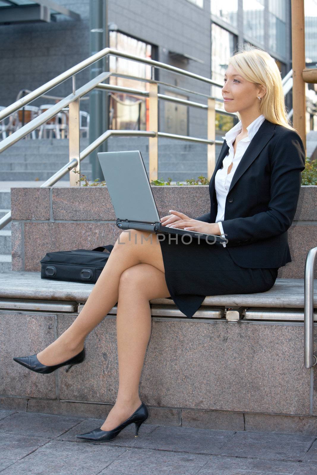 Businesswoman using laptop computer by Luminis