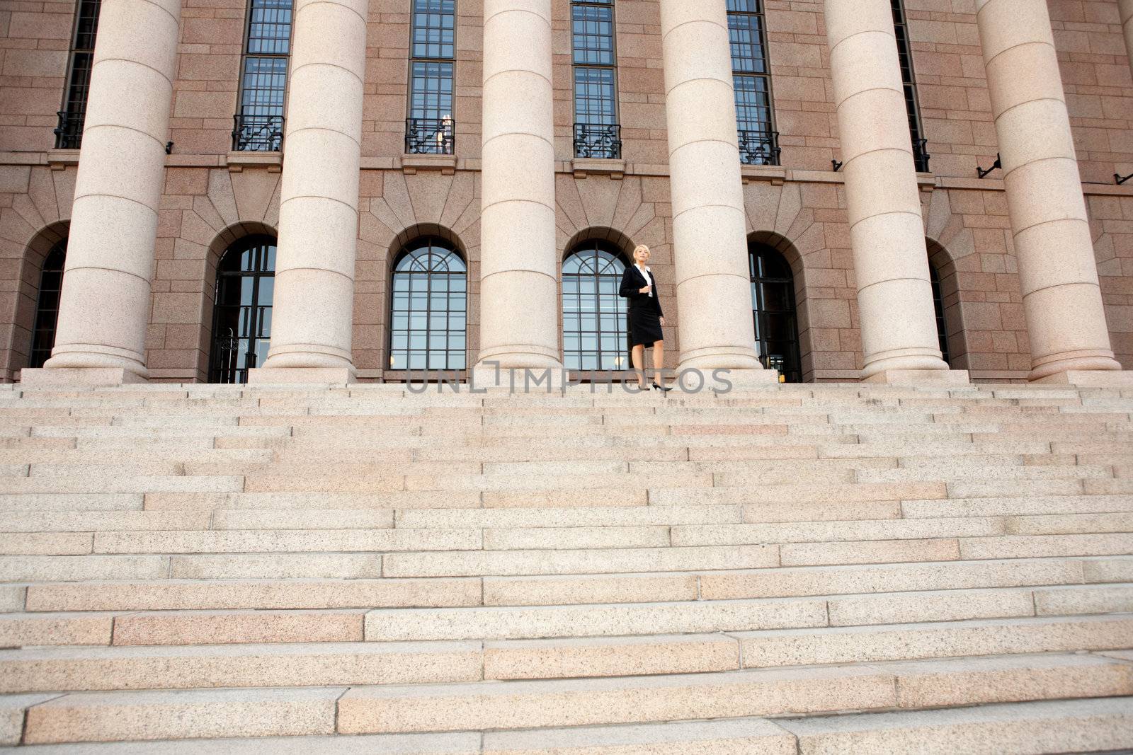 Businesswoman standing by building, wide angle view