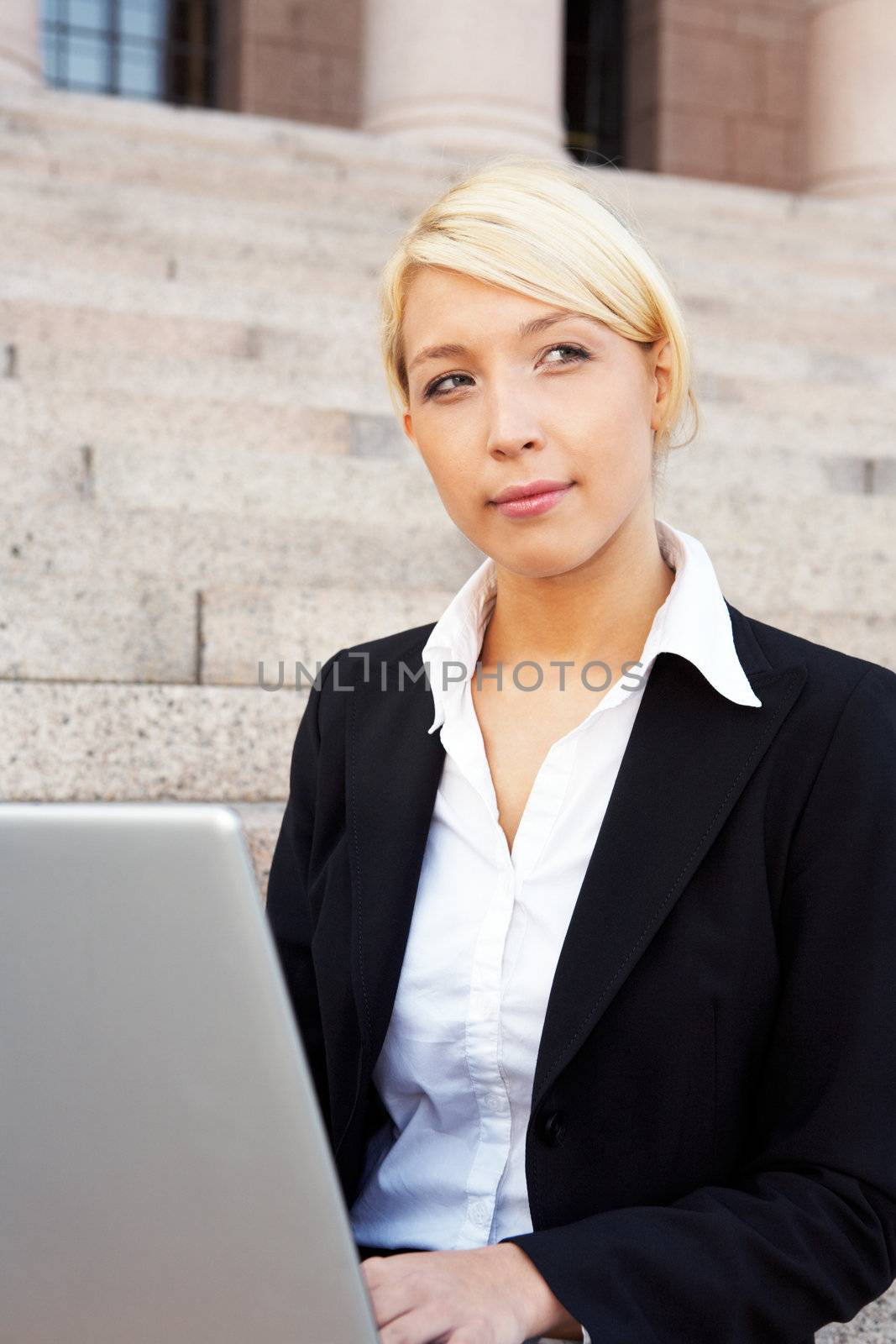 Businesswoman working with laptop computer, contemplating