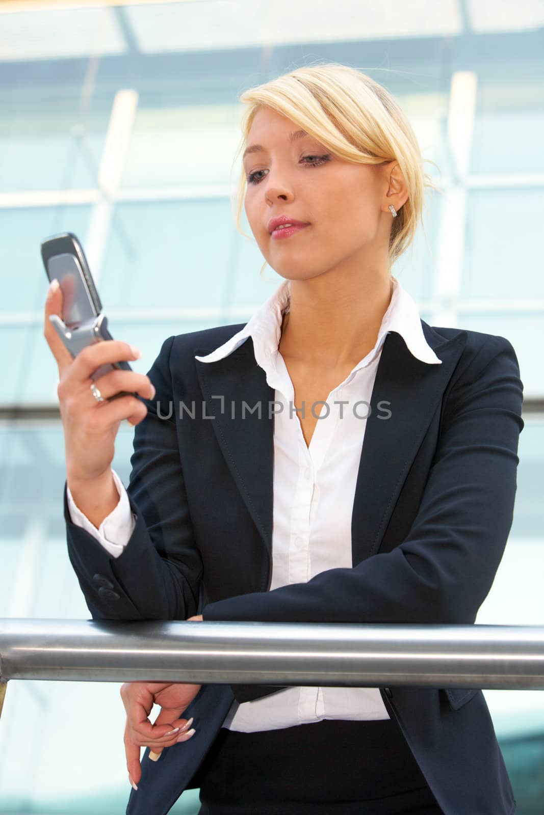 Businesswoman holding mobile phone, reading message