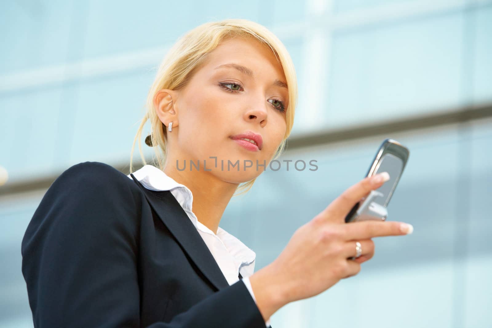 Businesswoman text messaging with mobile phone