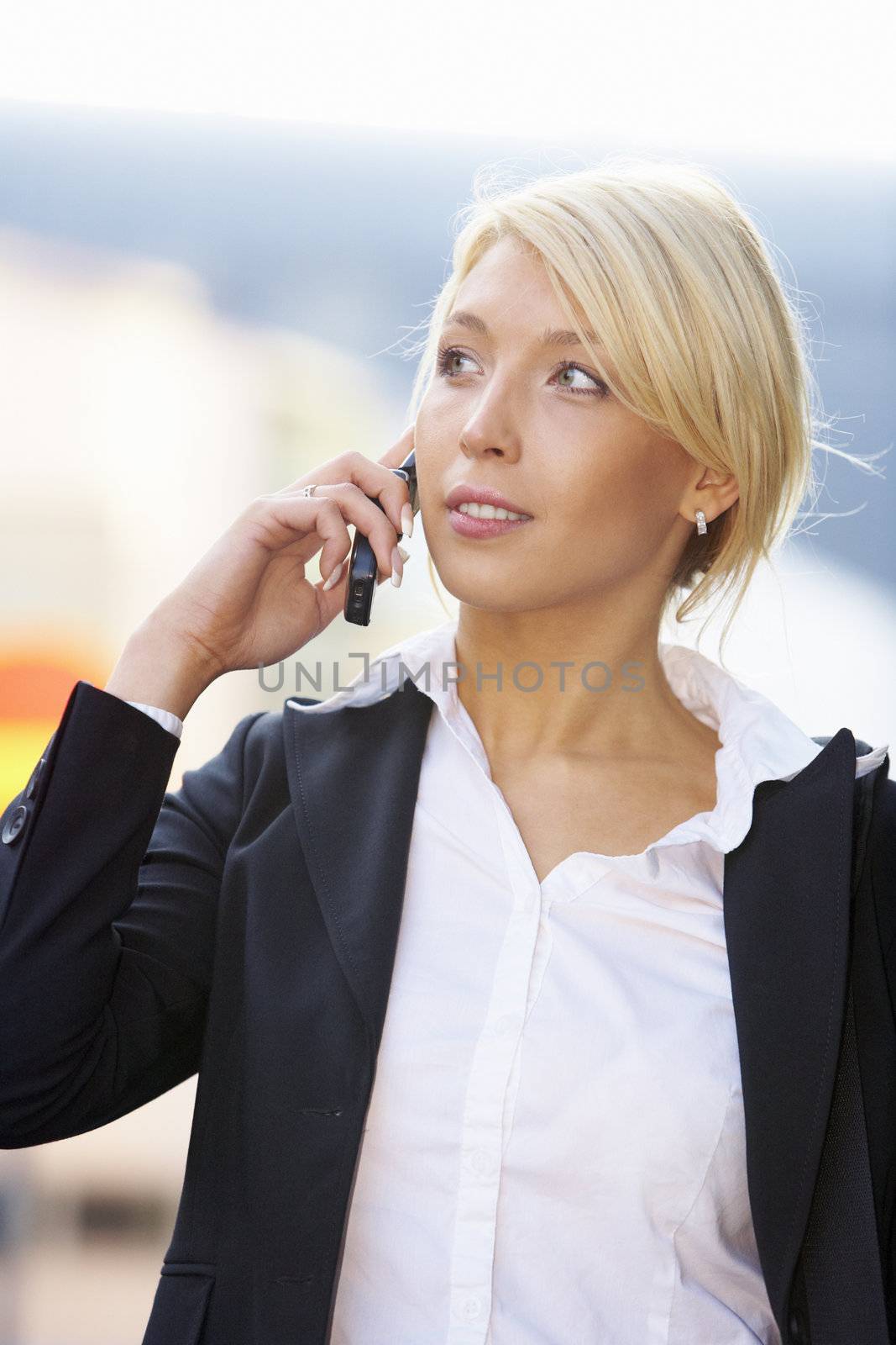 Young businesswoman using mobile phone while looking away
