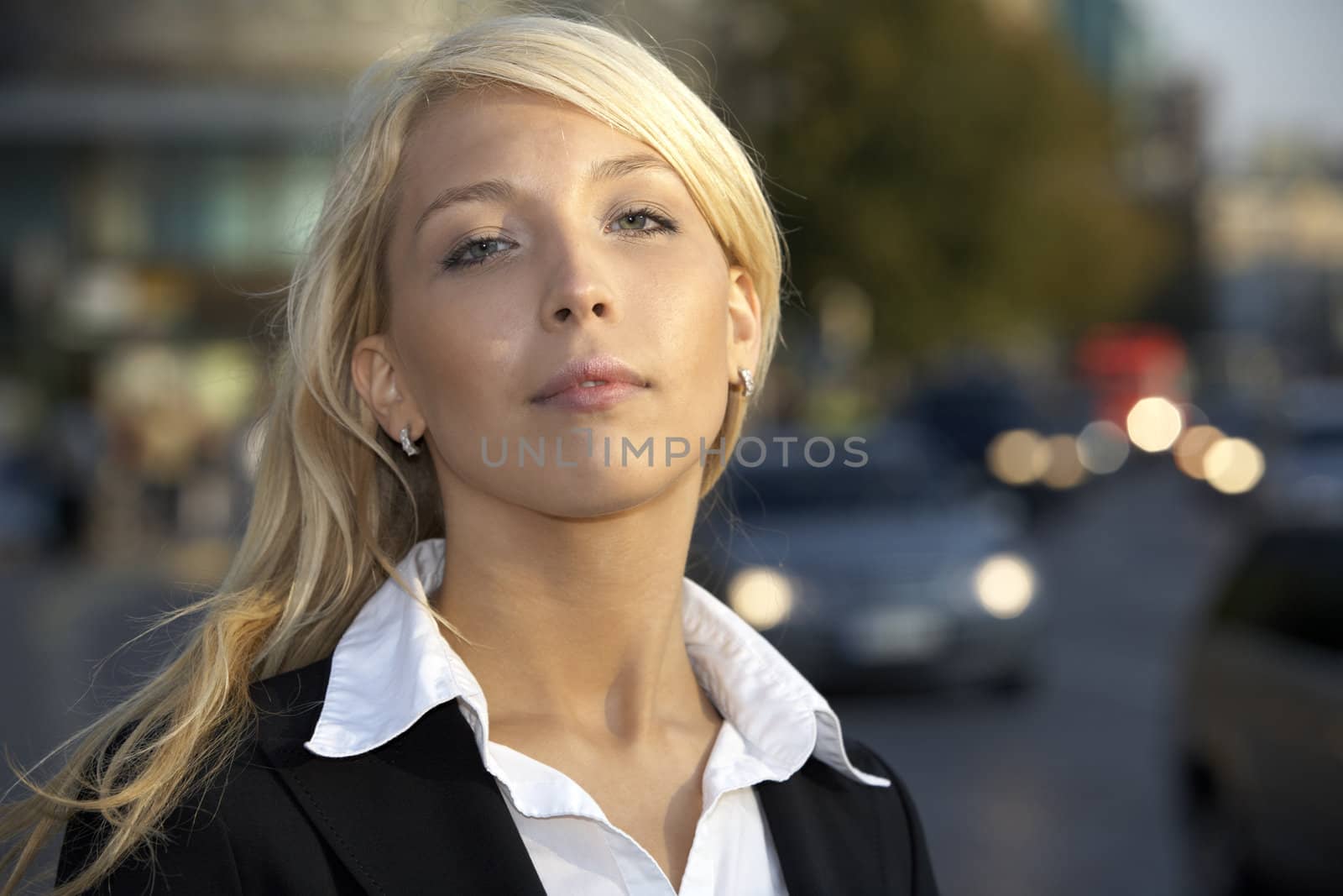 Portrait of young businesswoman in street at night