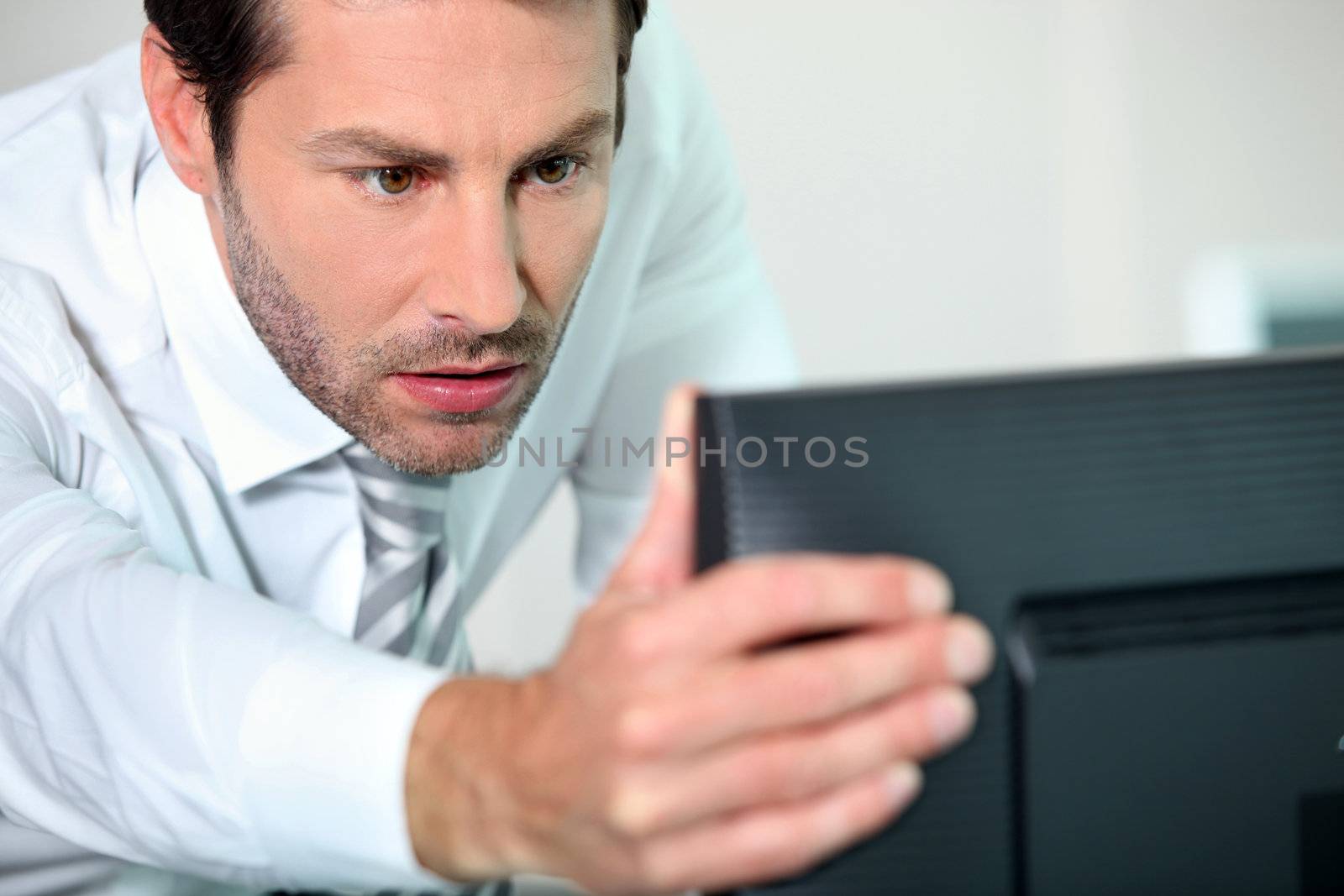 close-up of a man with computer by phovoir