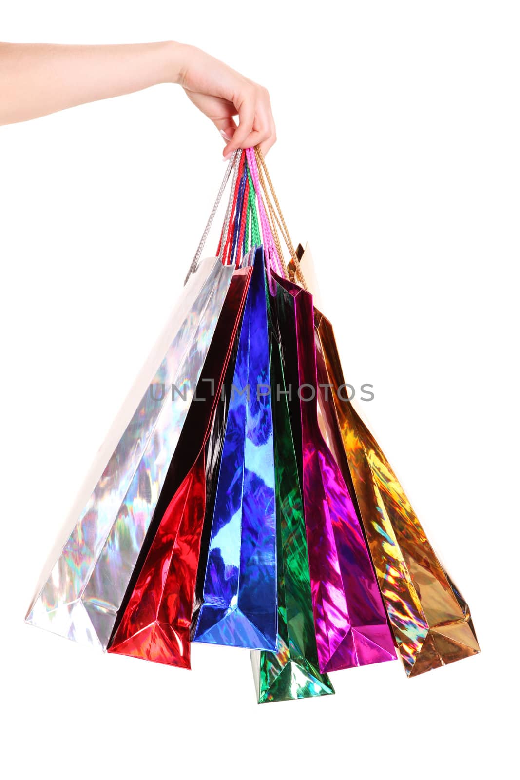 Female hand holding colorful shopping bags isolated on a white background 
