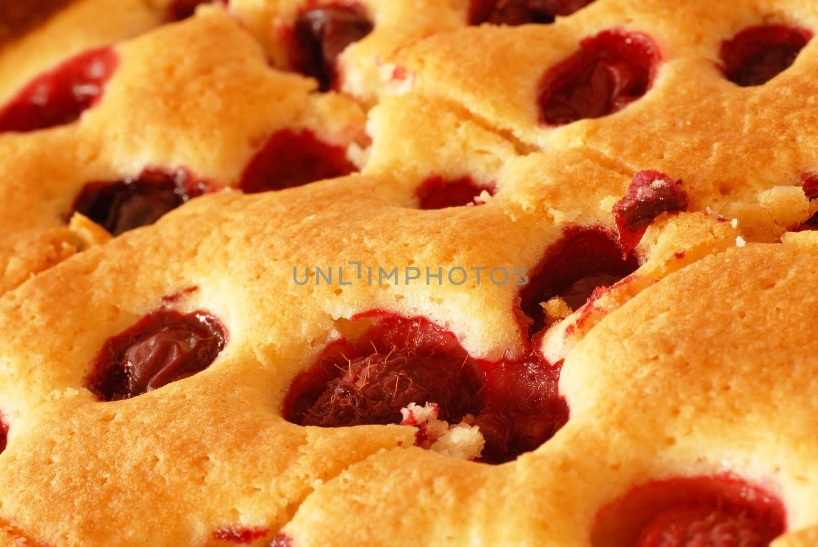baked fruity cake with cherries and raspberries macro background