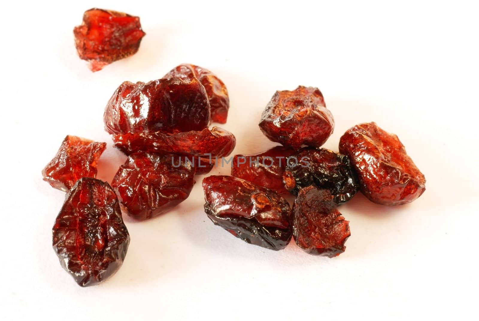 several dried cranberries over white background macro