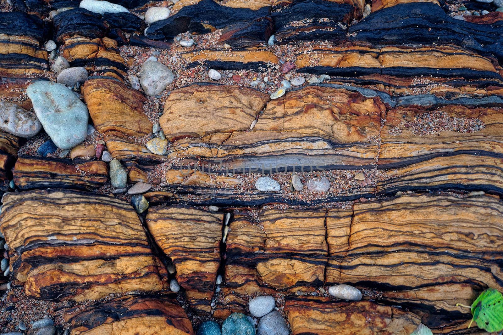 Natural stone structure and smallish pebbles between cracked