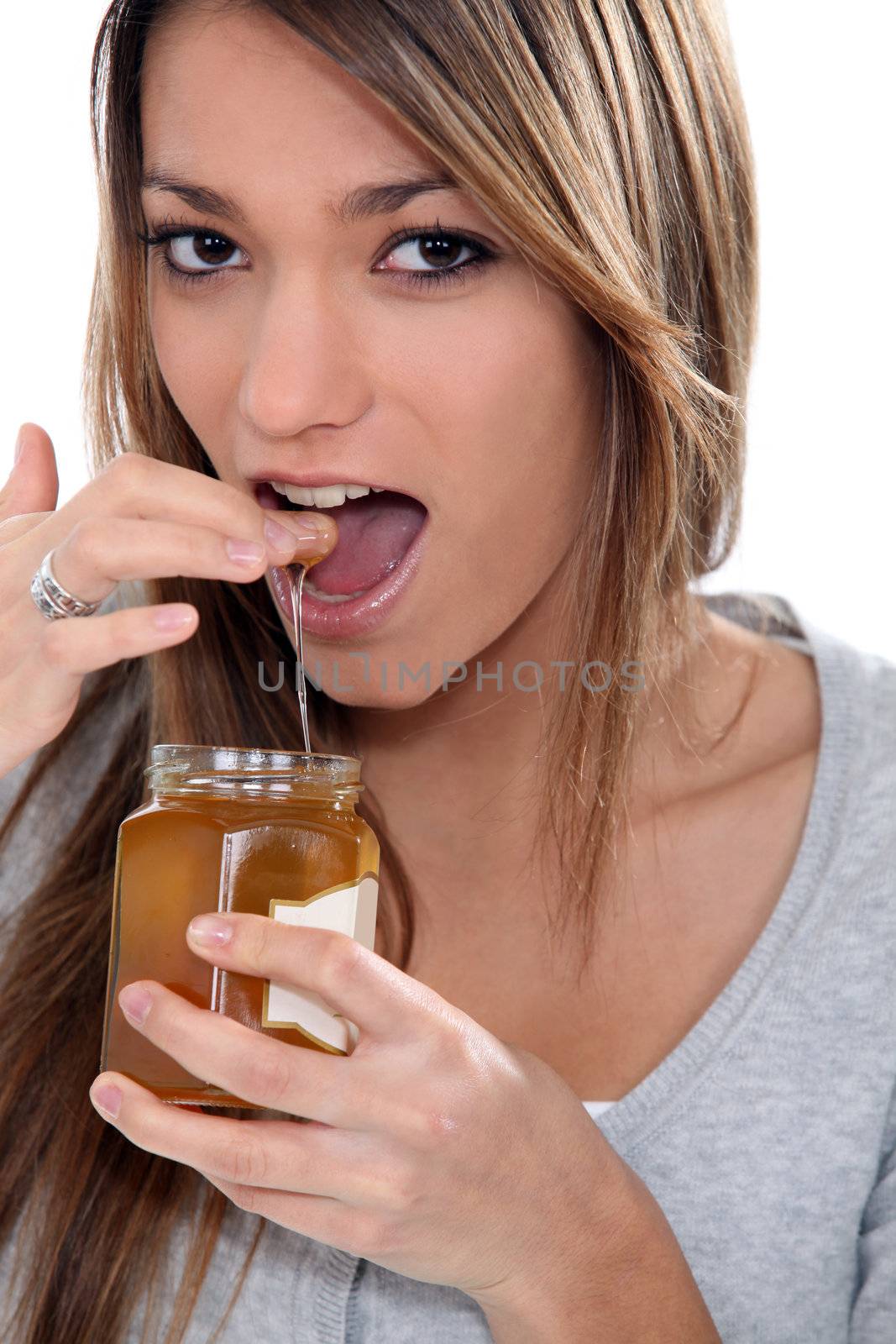 Girl eating honey by phovoir