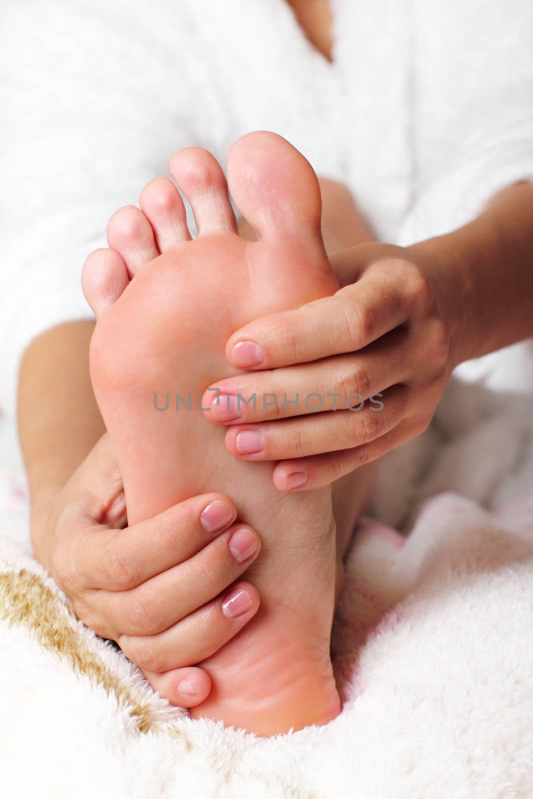 Young woman massaging his feet