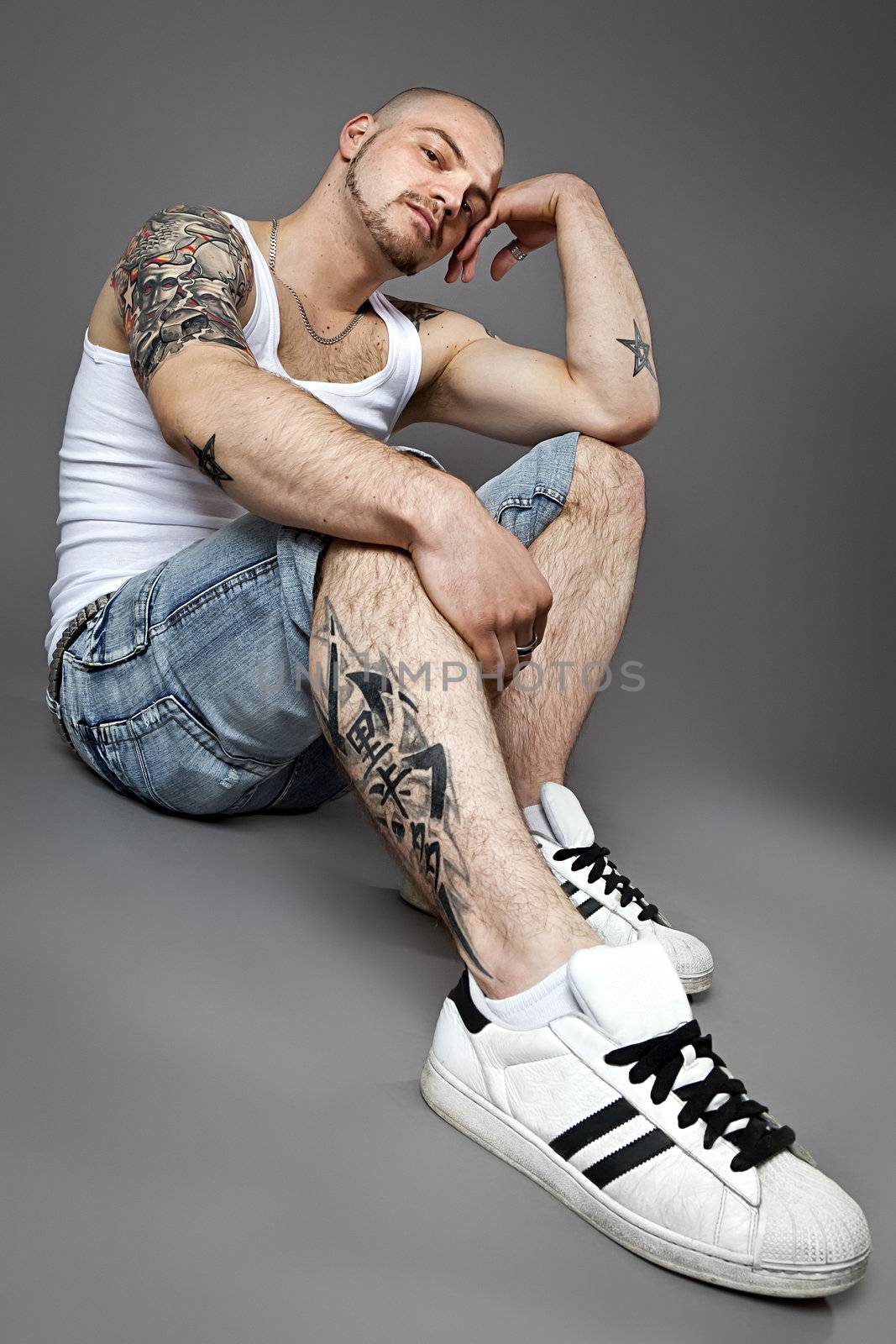 An image of a handsome man with tattoos