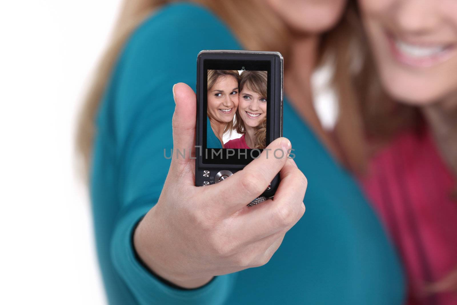 Two friends taking a picture of themselves. by phovoir