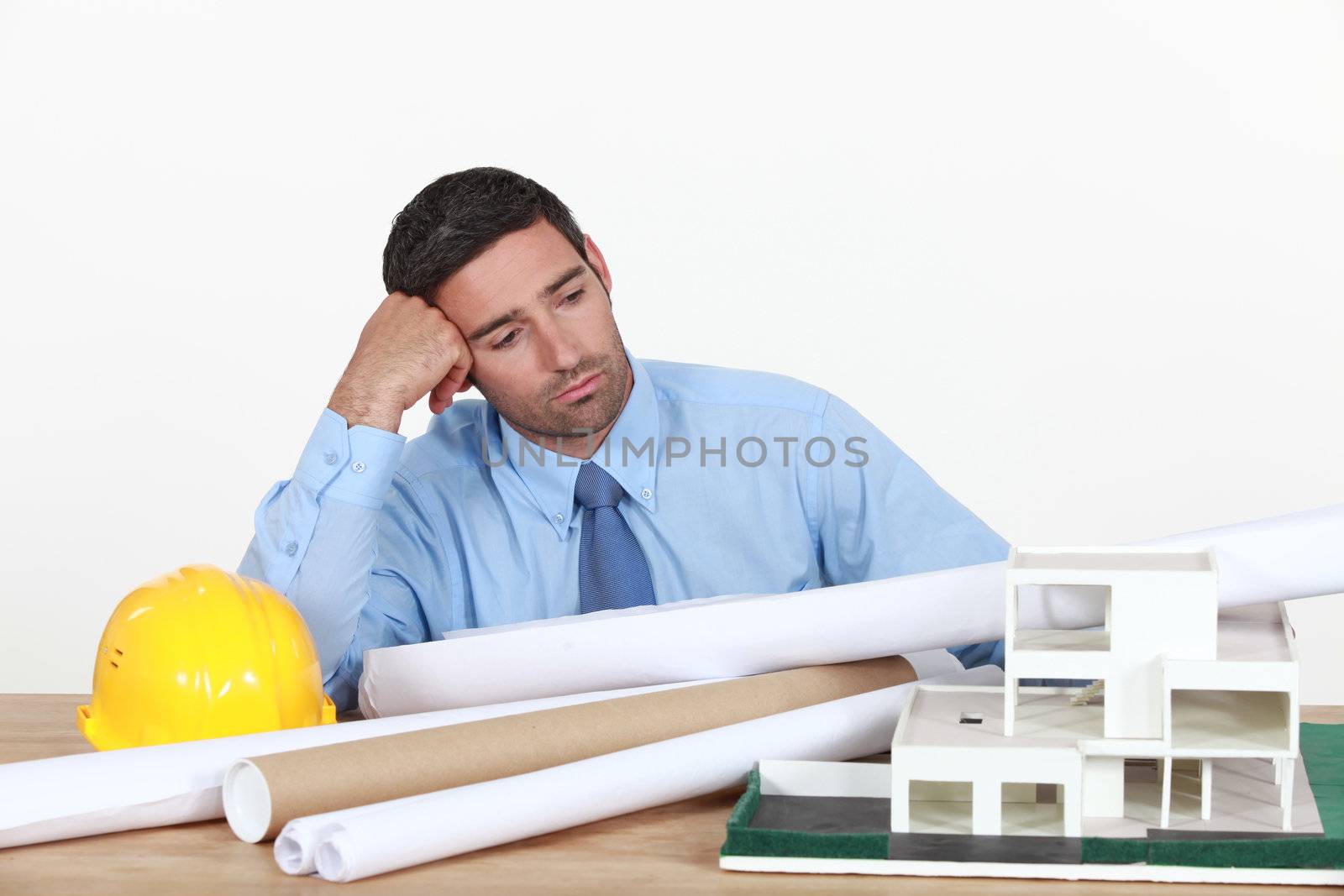 A bored architect at his desk. by phovoir