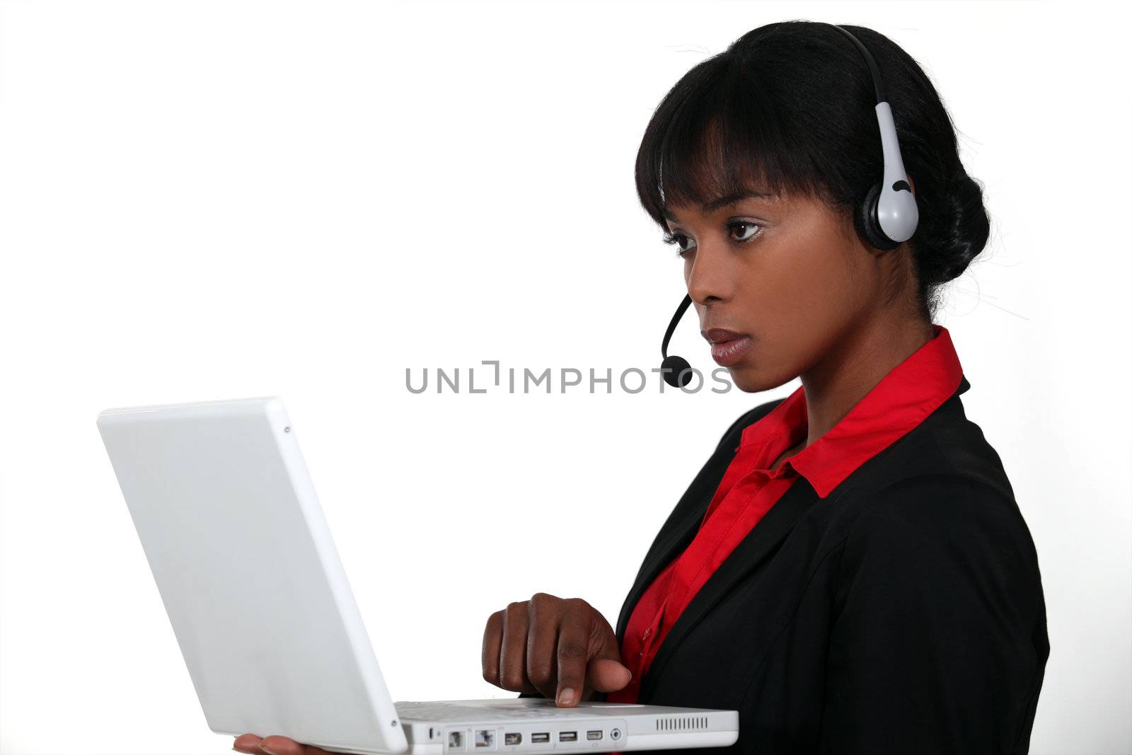 An African American businesswoman at work. by phovoir