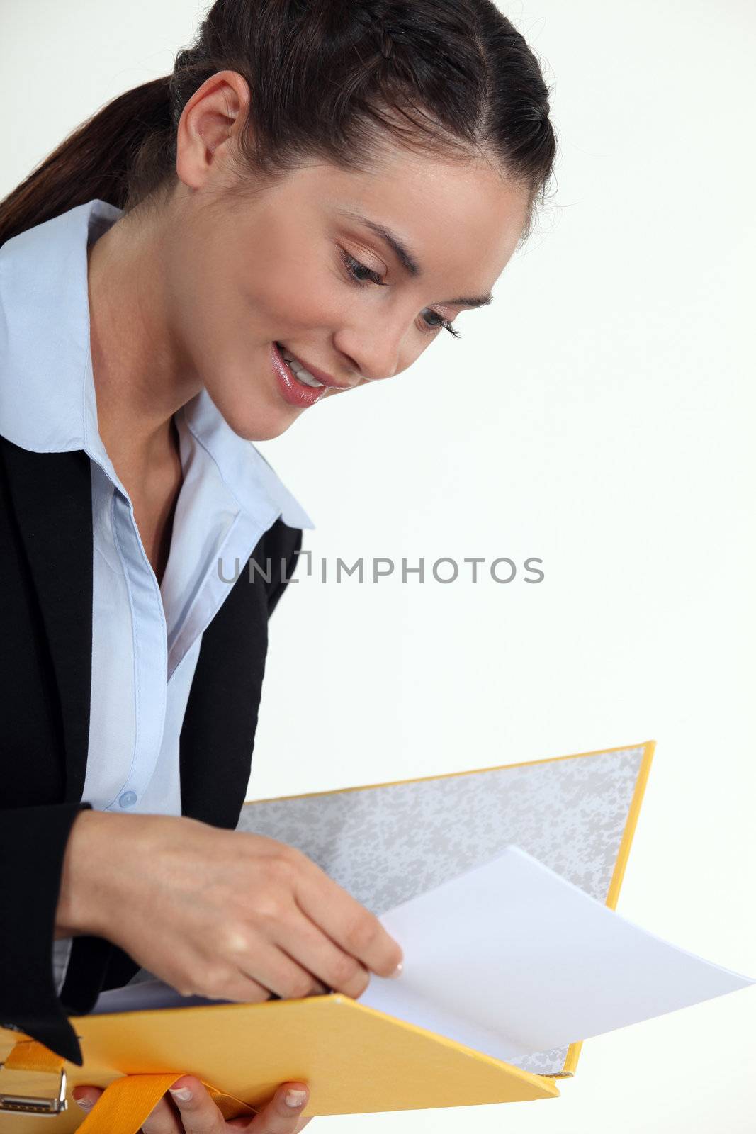 young businesswoman holding file looking pleased