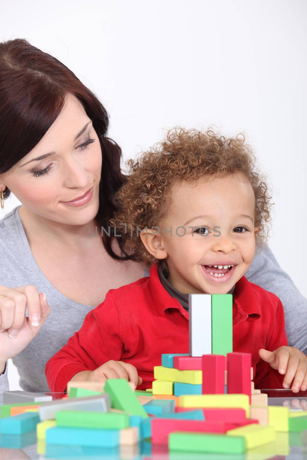 Mother and son with colourful building blocks by phovoir