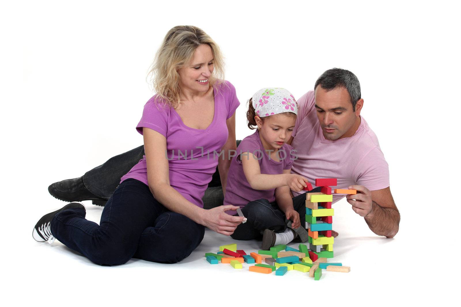 Couple and girl playing with blocks by phovoir